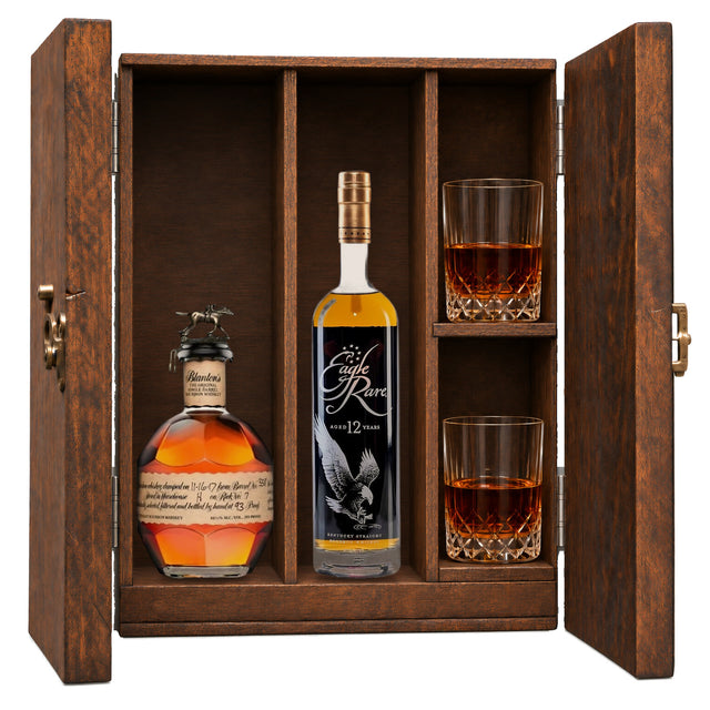 Blanton's Original Single Barrel & Eagle Rare 12 Year in a wooden gift box with two crystal glasses on white