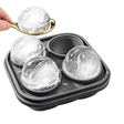 Premium whiskey ice sphere mold with spoon and large round ice balls on white background
