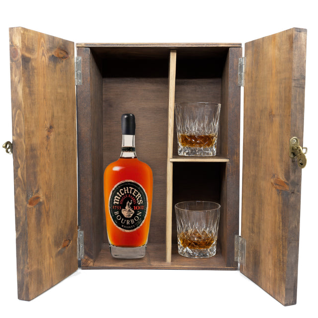 Michter's 10 Year Single Barrel Bourbon in a wooden gift box with two crystal glasses on white