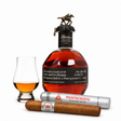 Blanton’s Black bourbon bottle with Glencairn glass, Montecristo cigar, and silver cigar tube