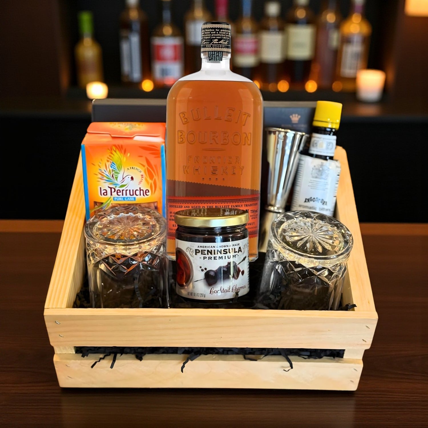 Collector’s Bulleit Bourbon Old Fashioned Gift Crate with whiskey, bar tools, cocktail cherries, bitters, and glasses on bar – Rare Bourbon Shop lifestyle photo