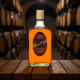 Elmer T. Lee Single Barrel Sour Mash Bourbon bottle photographed in a bourbon aging cellar with barrels in the background – exclusive release from Rare Bourbon Shop