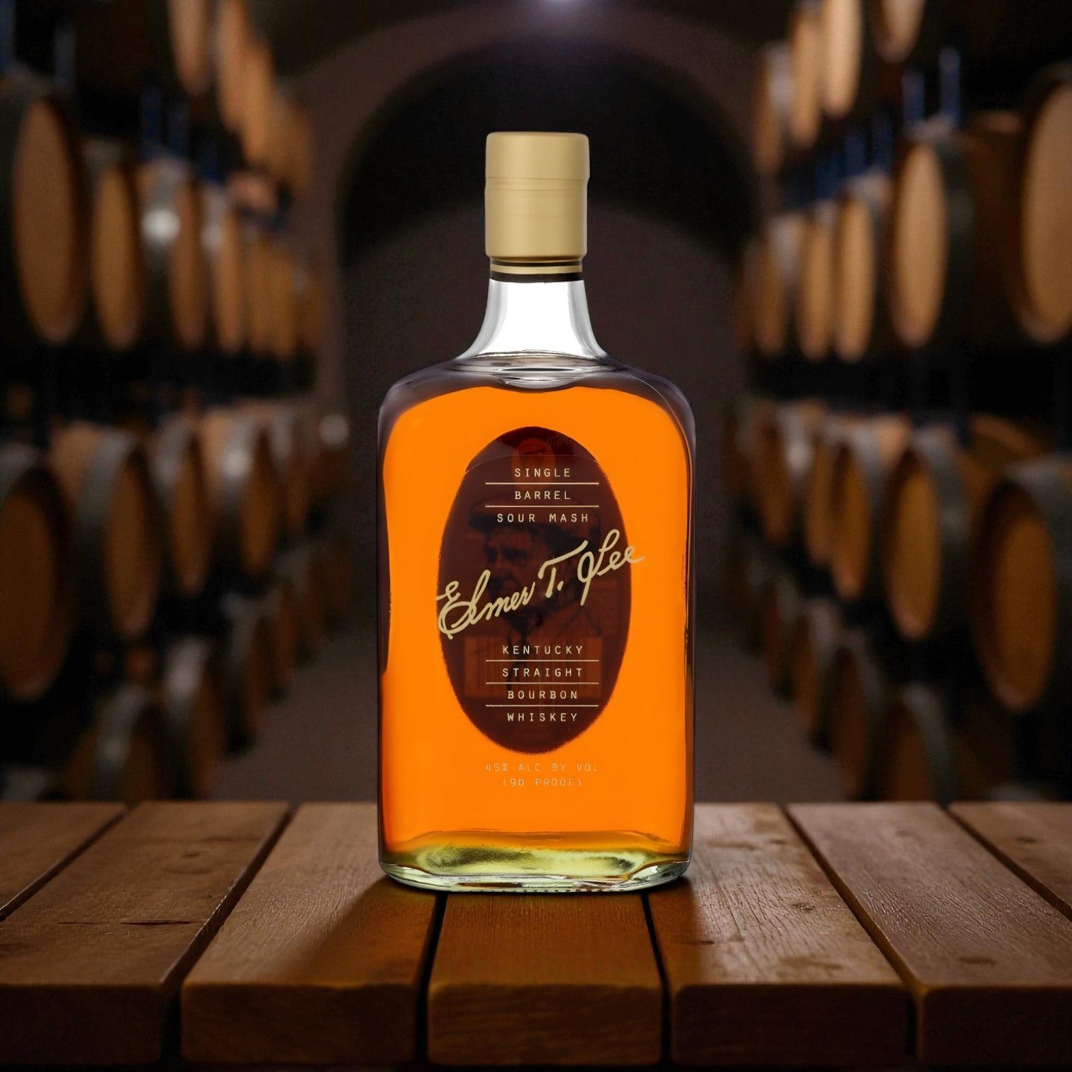Elmer T. Lee Single Barrel Sour Mash Bourbon bottle photographed in a bourbon aging cellar with barrels in the background – exclusive release from Rare Bourbon Shop