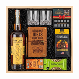 Colonel E.H. Taylor Barrel Proof Rye gift crate with two glasses, a leather bourbon journal and pen, whiskey stones, coffee, chocolate, and pistachios in a wood crate.