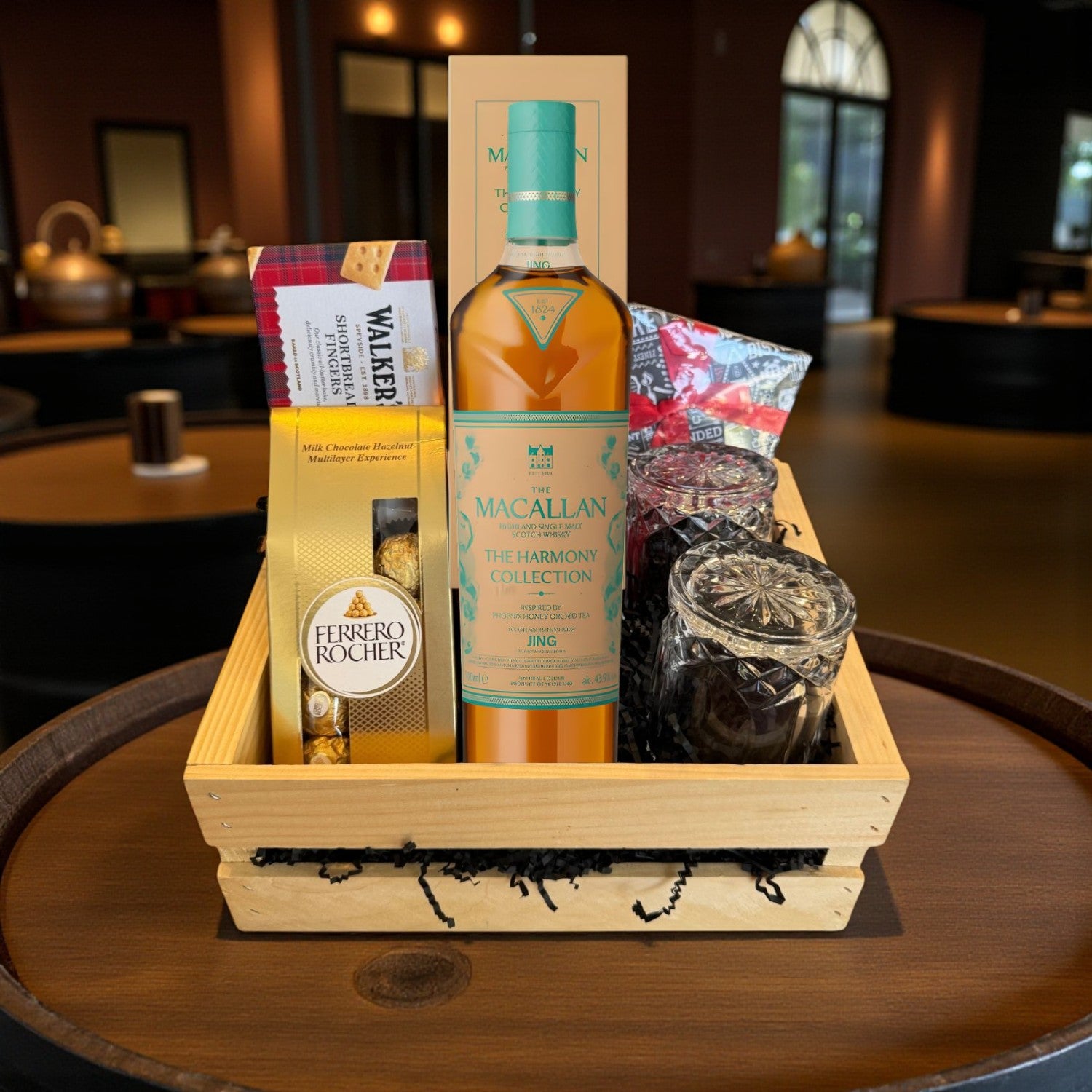 The Macallan Harmony Phoenix Honey Orchid Tea Single Malt Scotch Gift Crate with chocolates, shortbread, and crystal glasses in a premium wooden crate – lifestyle image for Rare Bourbon Shop