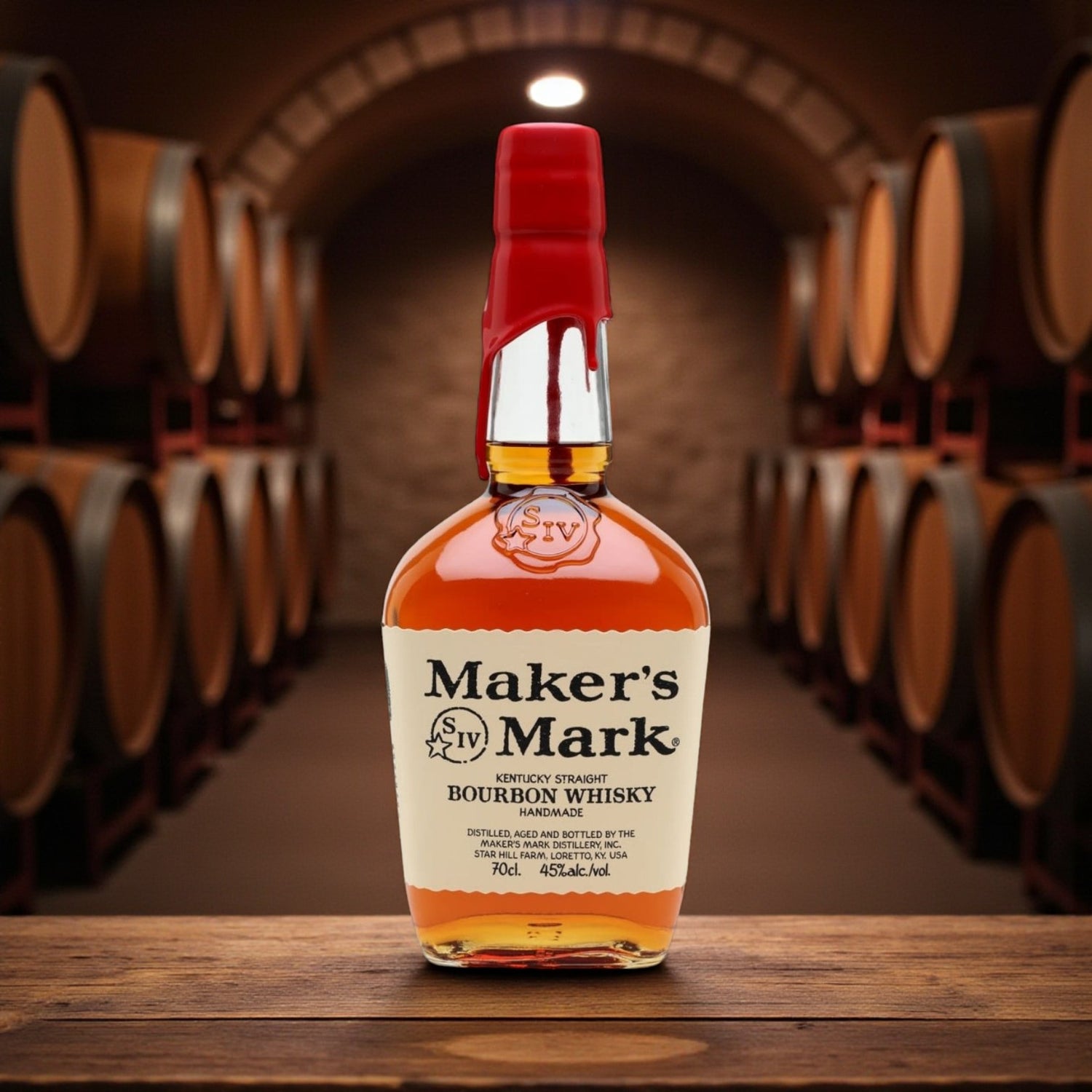 Maker’s Mark Kentucky Straight Bourbon Whisky bottle with red wax seal on wooden table surrounded by bourbon barrels – Rare Bourbon Shop lifestyle photo