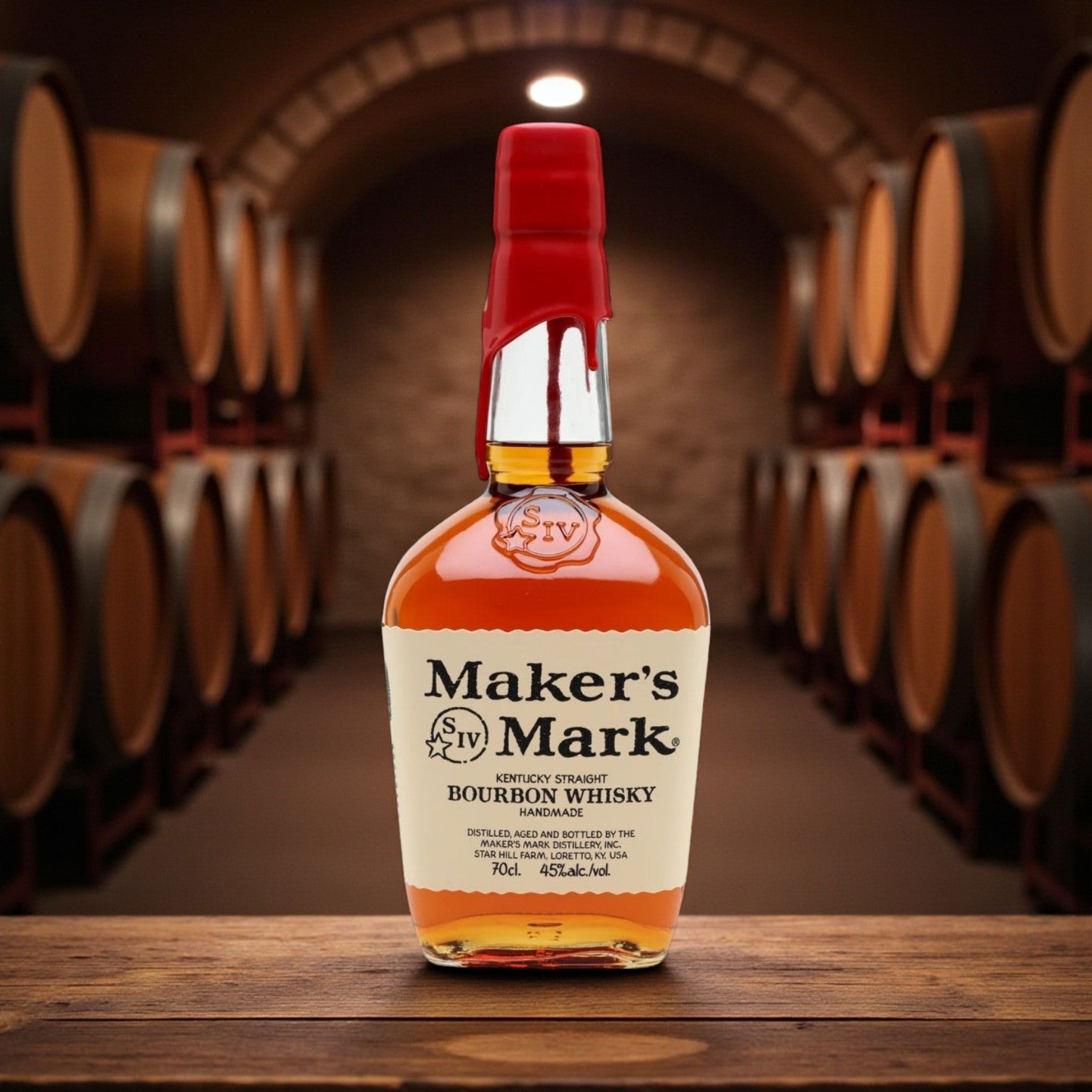 Maker’s Mark Kentucky Straight Bourbon Whisky bottle with red wax seal on wooden table surrounded by bourbon barrels – Rare Bourbon Shop lifestyle photo