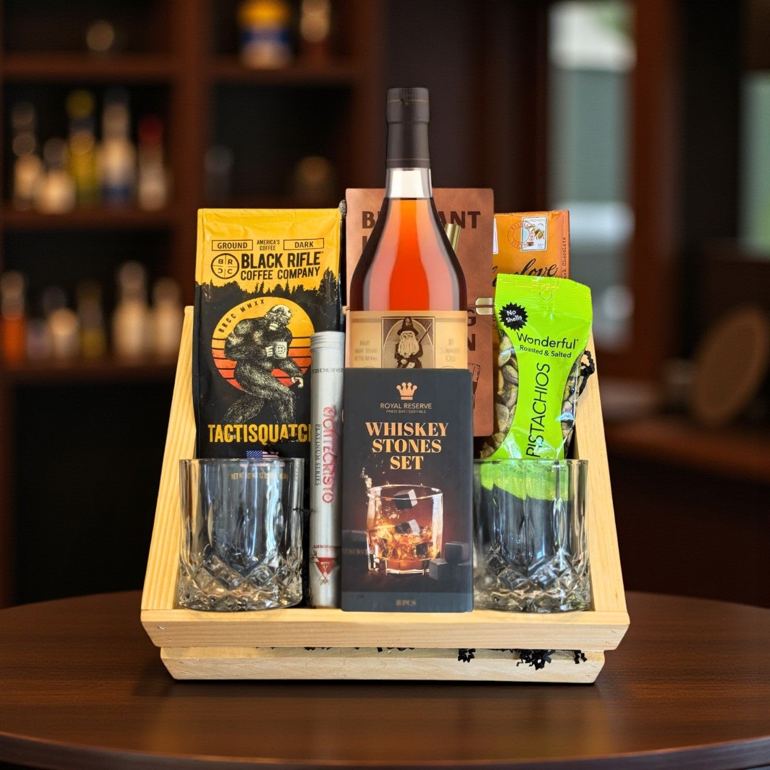 Collector’s Old Rip Van Winkle 10 Year Top Shelf Gift Crate with bourbon, coffee, chocolate, pistachios, cigar, whiskey stones, journal, and glasses displayed on wooden table – Rare Bourbon Shop lifestyle photo