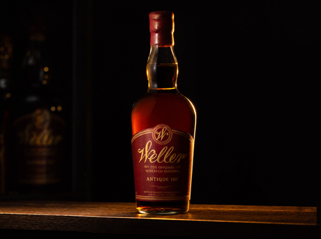 W.L. Weller Antique 107 bottle in a dark editorial scene with warm rim light