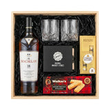 The Macallan 18 Year Double Cask Single Malt Scotch Whisky 750ml gift crate with crystal-cut old fashioned glasses, premium whiskey stones, Ferrero Rocher chocolates, and Walker's Shortbread Fingers in natural wood crate with black crinkle fill