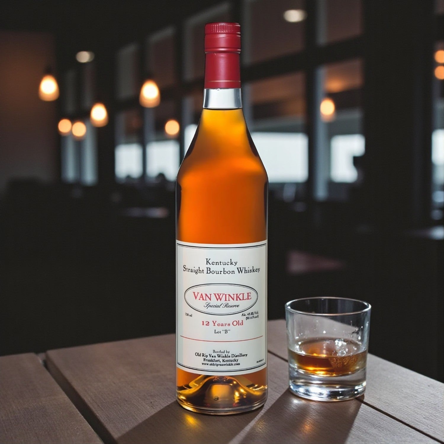 Collector’s Pappy Van Winkle Special Reserve 12 Year Lot B Bourbon bottle on wooden table beside glass of bourbon with soft bar lighting – Rare Bourbon Shop lifestyle photo