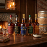 W.L. Weller Bourbon Collector's Bundle lifestyle scene featuring five 750ml bottles - Antique 107, 12 Year, Full Proof, Special Reserve, and Single Barrel - displayed together with crystal bourbon glasses on rich dark wood surface in rustic-luxe bourbon den setting with warm ambient lighting.